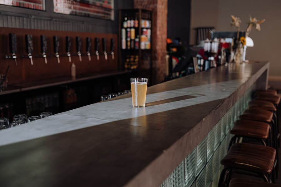 A hazy schooner of Haze Kettle IPA on the long concrete bar