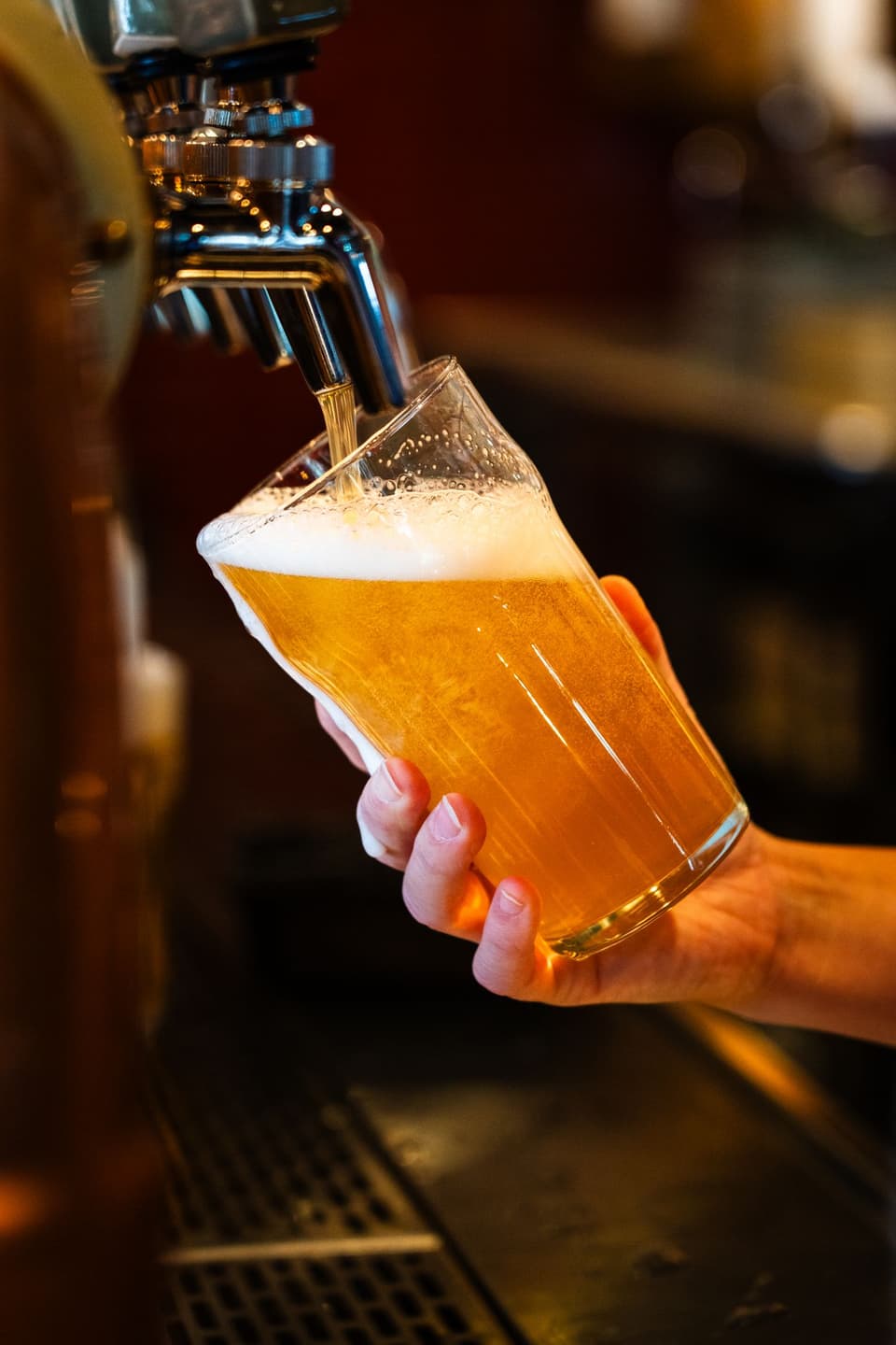 Grist Lager pouring into a tall glass