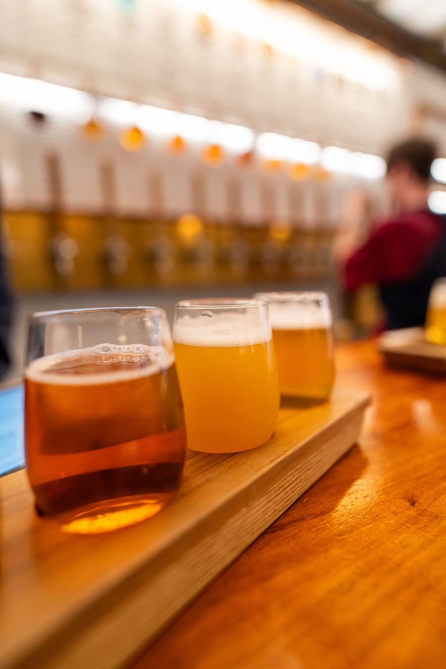A paddle of four beers, pale to amber, on the bar at Grist